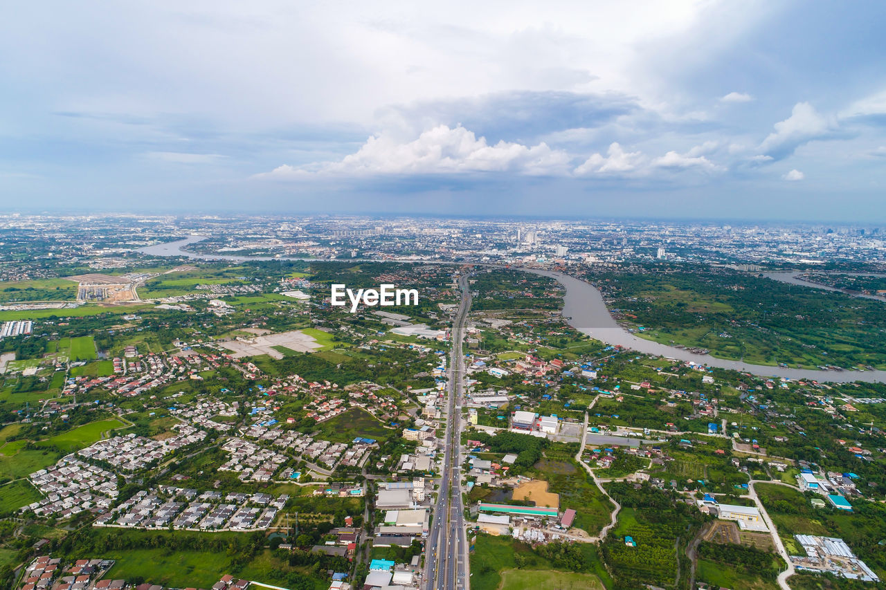 HIGH ANGLE VIEW OF TREES AND BUILDINGS AGAINST SKY