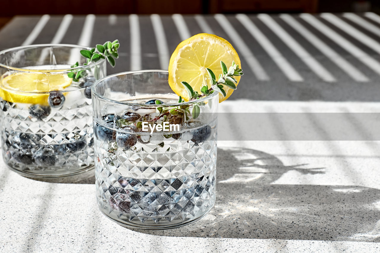 Fresh summer drink blueberry mojito or blueberry icy lemonade with lemon, blueberries,ice and thyme.