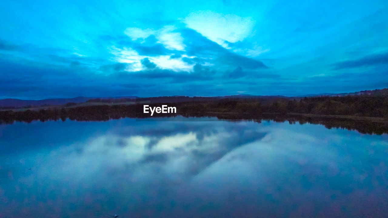 SCENIC VIEW OF REFLECTION OF CLOUDS IN LAKE
