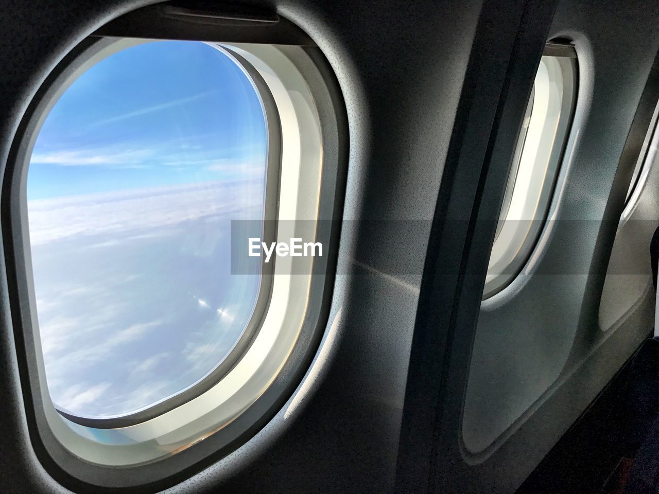 AIRPLANE WING SEEN THROUGH WINDOW OF BUS