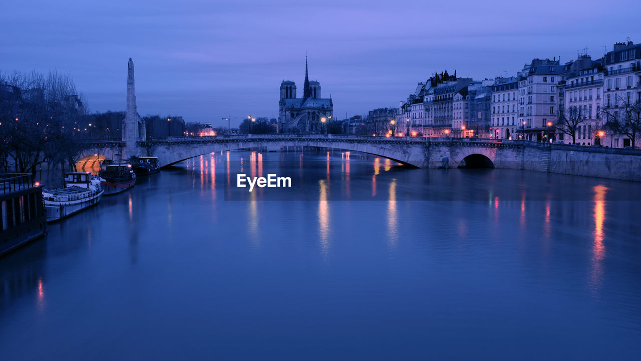 View of illuminated bridge over river