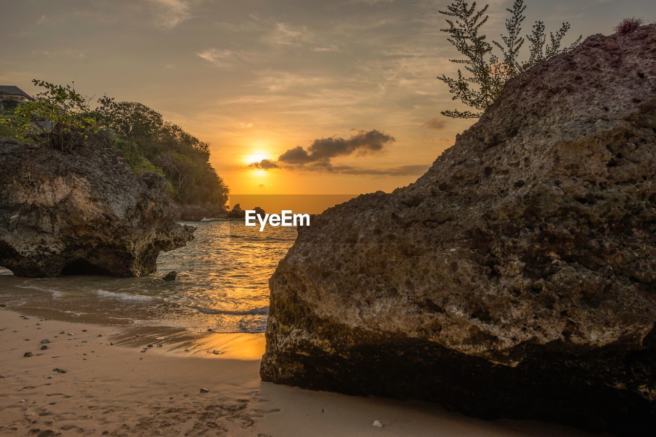 Scenic view of beach against sky during sunset