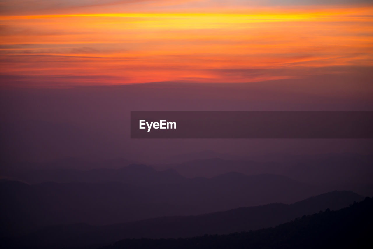 SCENIC VIEW OF SILHOUETTE MOUNTAINS AGAINST ROMANTIC SKY