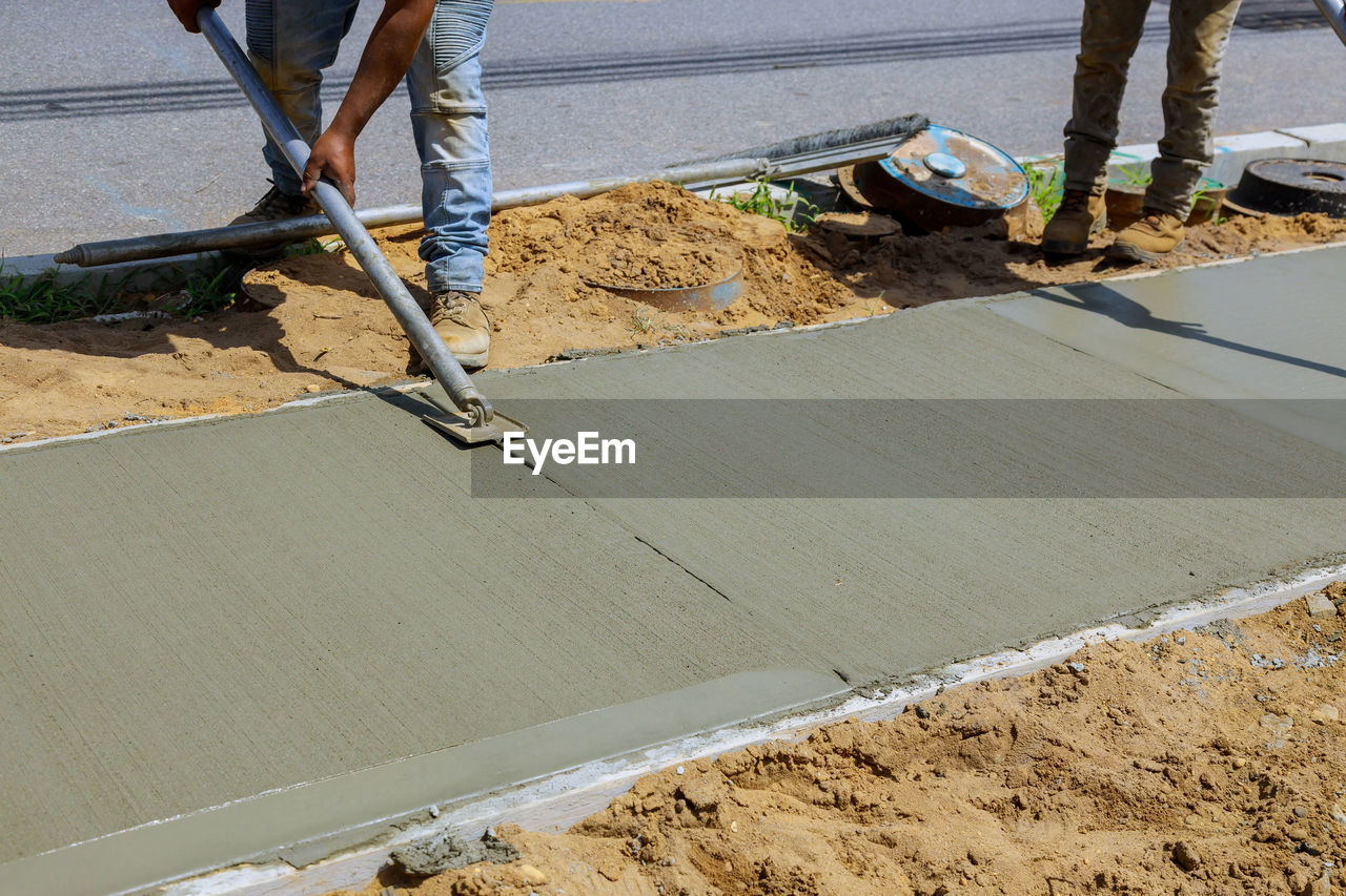 LOW SECTION OF MAN WORKING ON ROAD