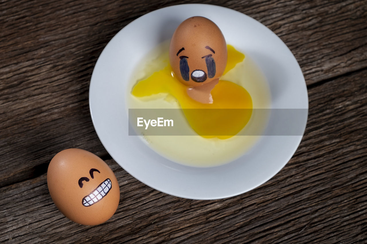 High angle view of emoji eggs on table