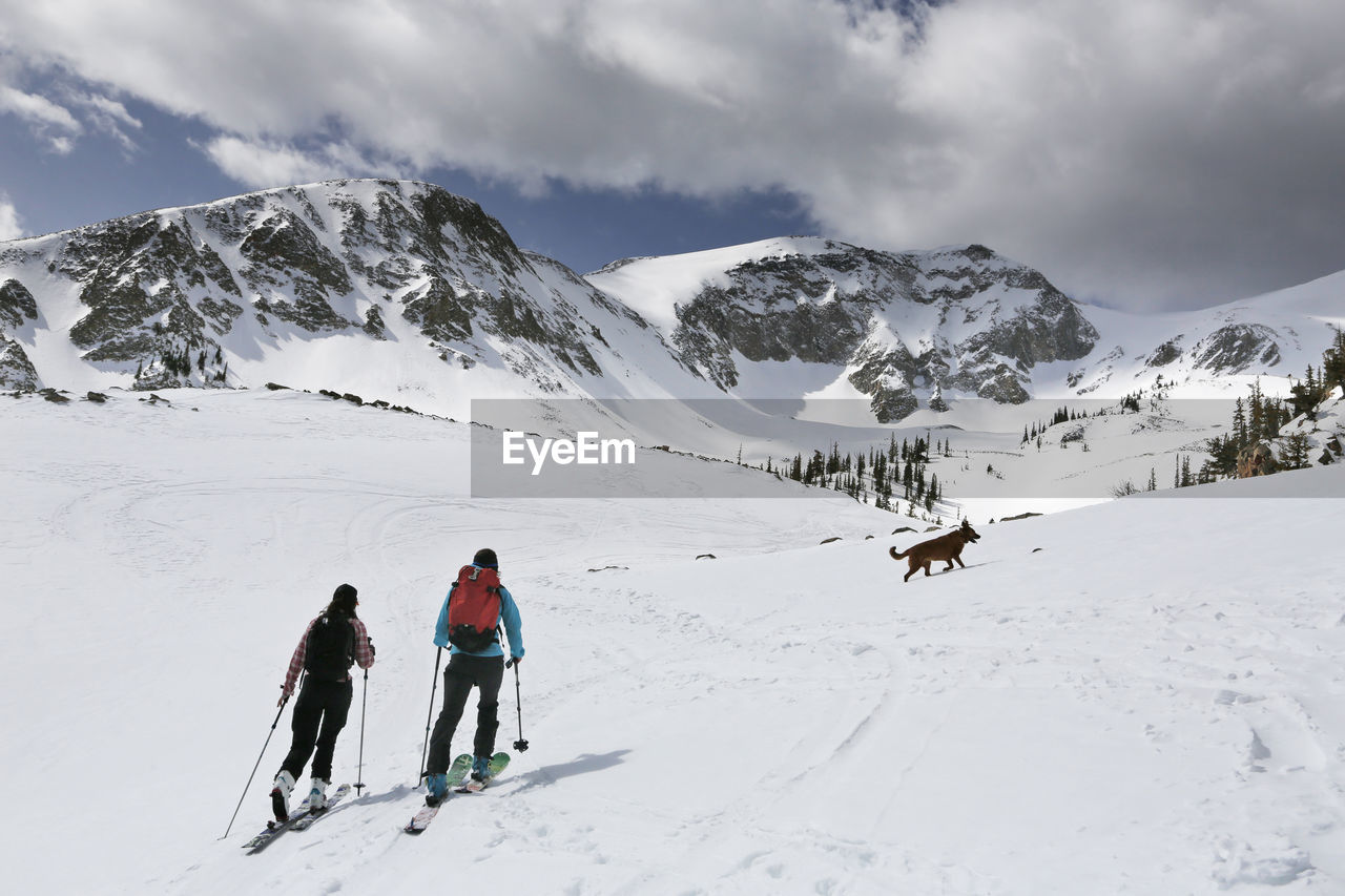 Two women ski up mount sopris with a dog in colorado