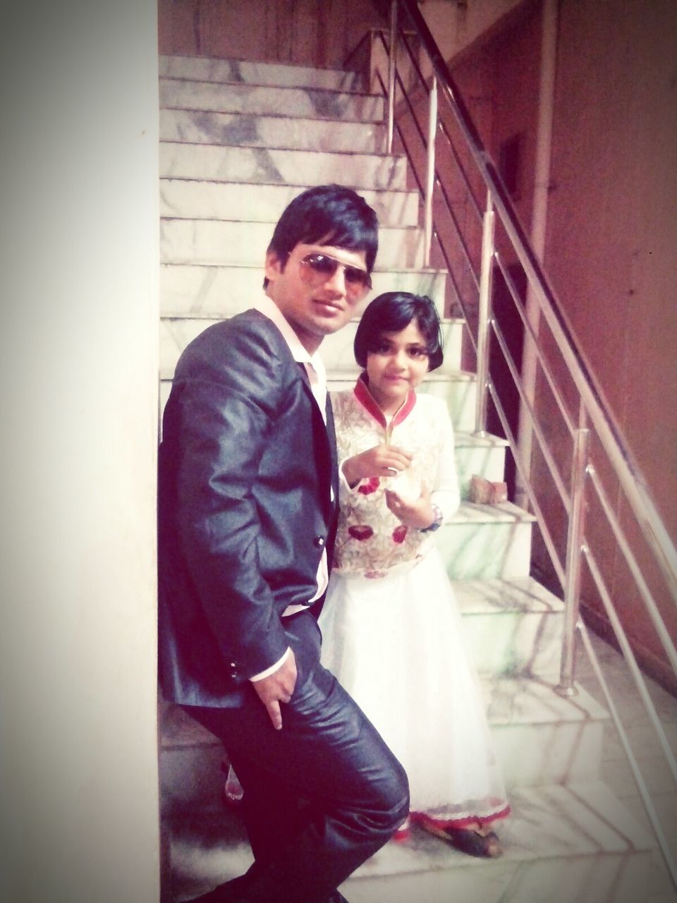 PORTRAIT OF HAPPY YOUNG COUPLE IN CORRIDOR OF ROOM