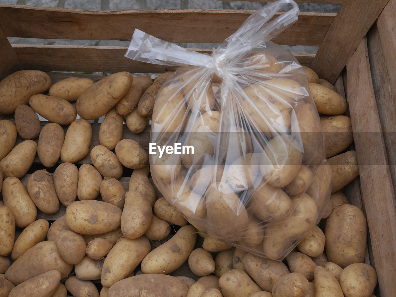 High angle view of potatoes in plastic bag for sale at market