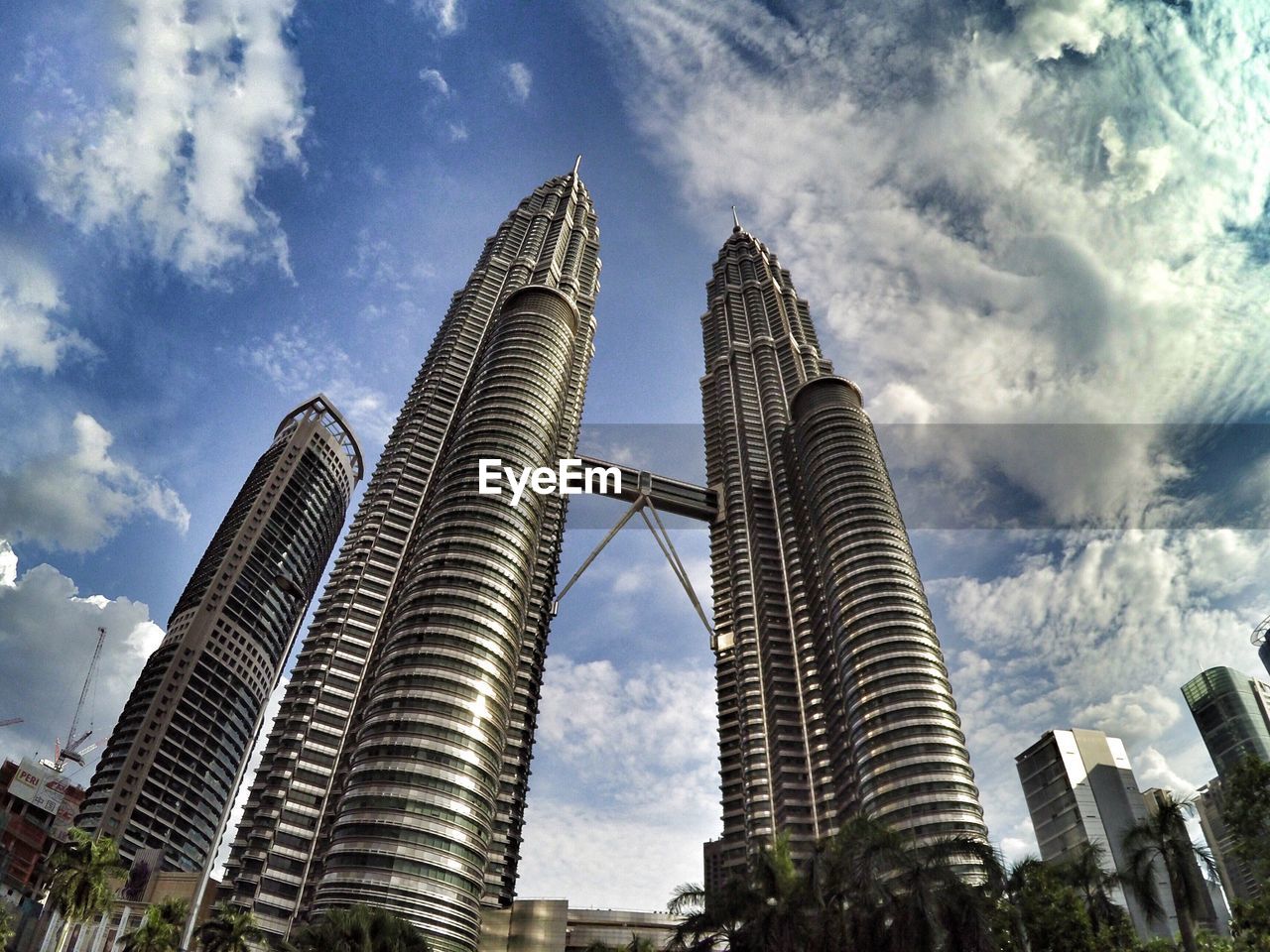 Low angle view of modern building against cloudy sky