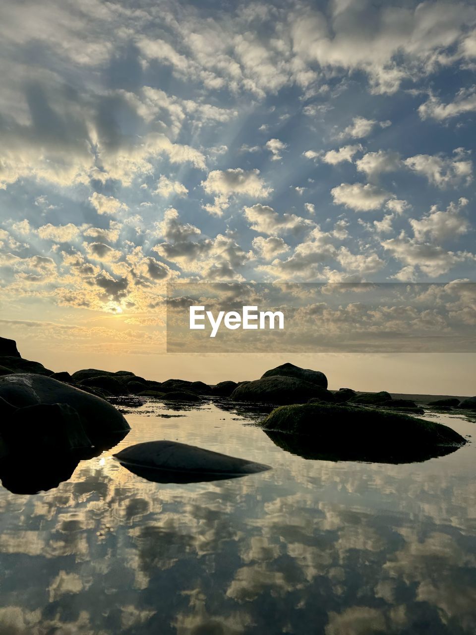 reflection, sky, cloud, water, sea, horizon, sunset, sunlight, nature, beauty in nature, scenics - nature, ocean, coast, tranquility, rock, dusk, no people, environment, tranquil scene, evening, land, wave, shore, landscape, beach, outdoors, idyllic, dramatic sky, silhouette, travel destinations, sun, non-urban scene