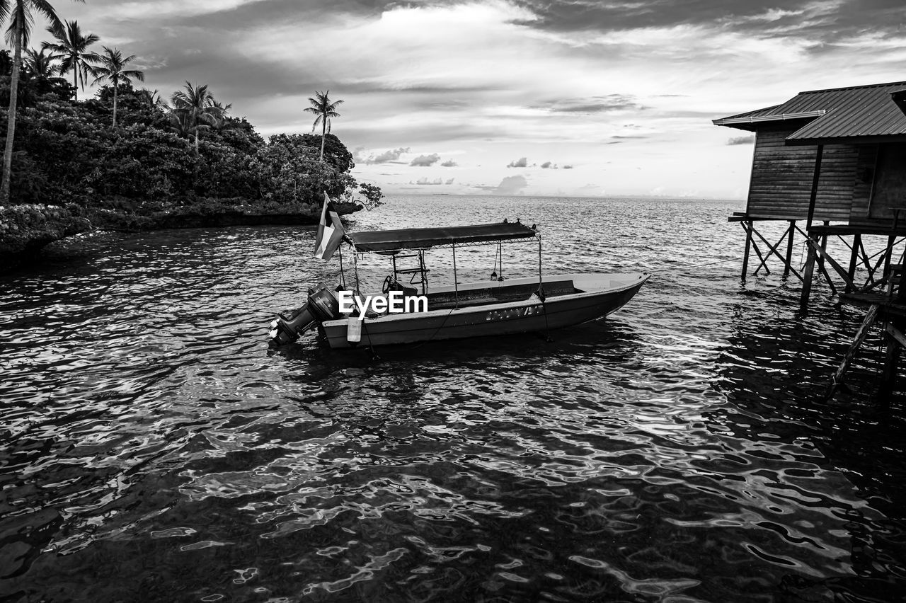 water, nautical vessel, transportation, sky, mode of transportation, cloud, black and white, nature, sea, monochrome photography, monochrome, boat, beauty in nature, vehicle, day, travel, architecture, beach, outdoors, no people, scenics - nature, tranquility, land, tree, black, built structure, travel destinations, reflection, tranquil scene, plant, holiday, rippled, coast, moored, watercraft, tropical climate