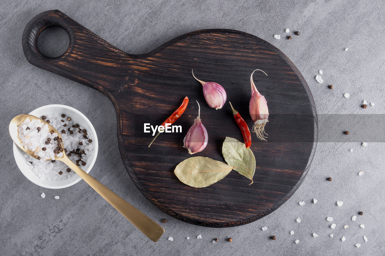 food and drink, food, wood, freshness, spice, directly above, leaf, no people, ingredient, high angle view, kitchen utensil, still life, gray, healthy eating, spoon, indoors, table, wellbeing, eating utensil, fruit, flower, household equipment, studio shot, still life photography, plant part