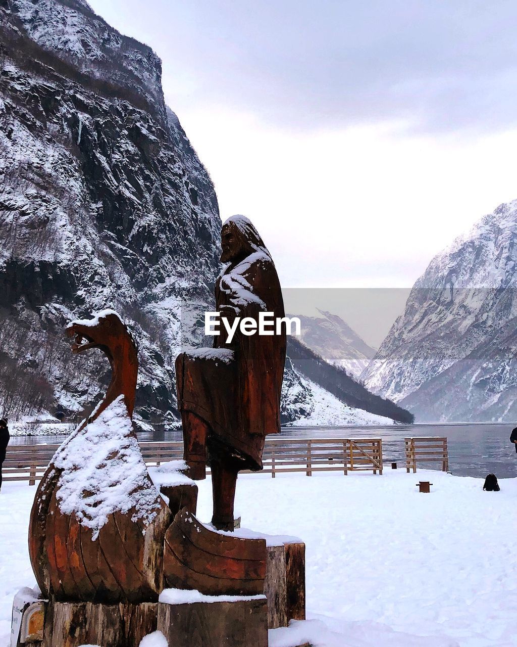 Snow covered rocks against sky