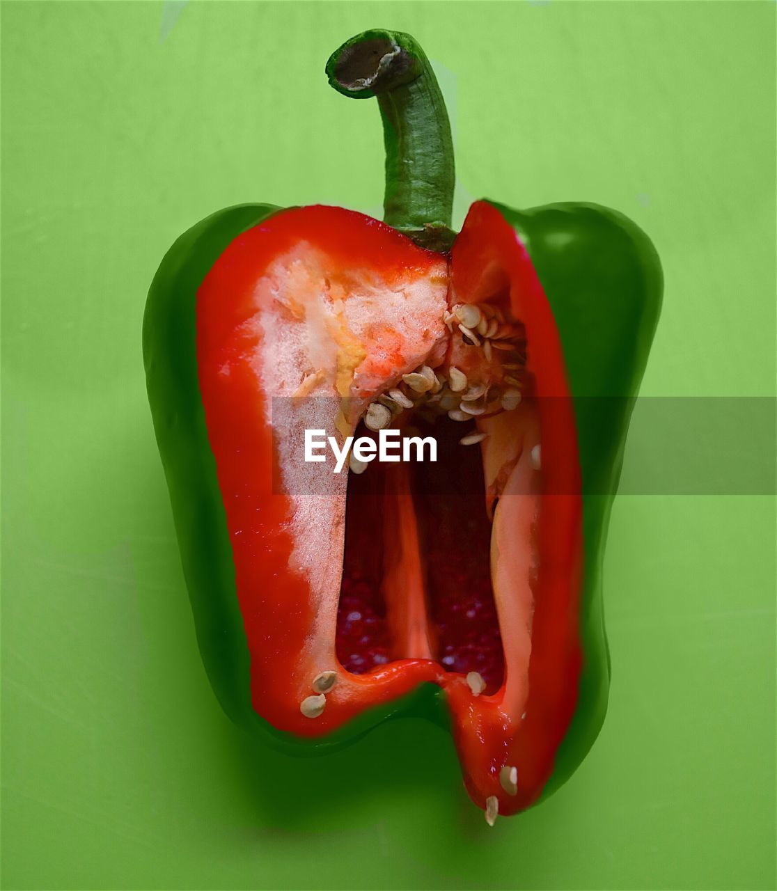 Mixture of red and green bell pepper over colored background