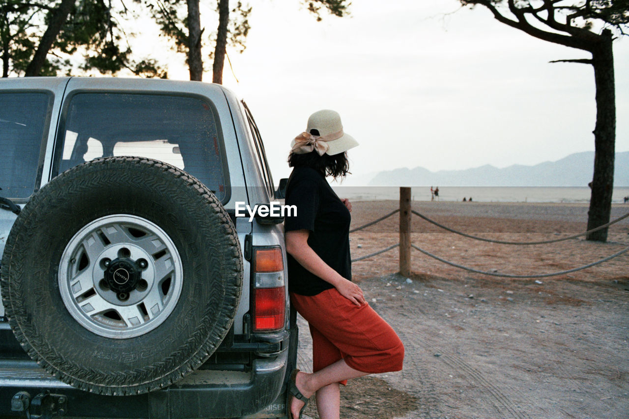 Woman standing near by suv