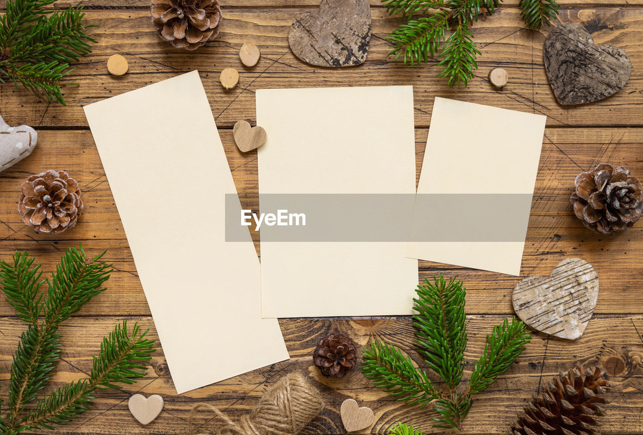 Winter christmas composition with a blank cards on a wooden table 