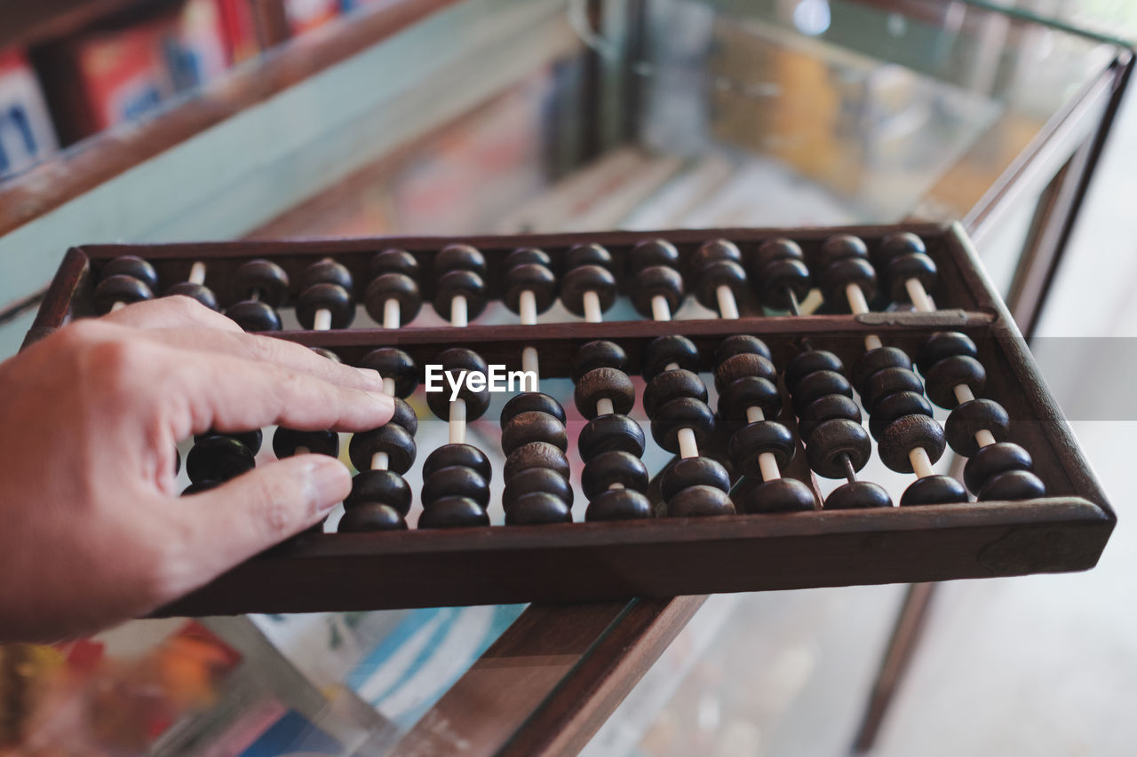 Cropped hand playing abacus