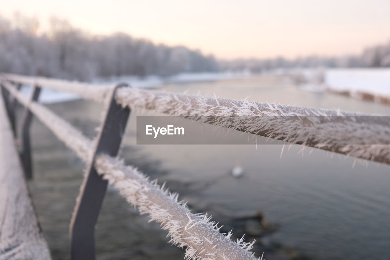 CLOSE-UP OF ICE ON RAILING