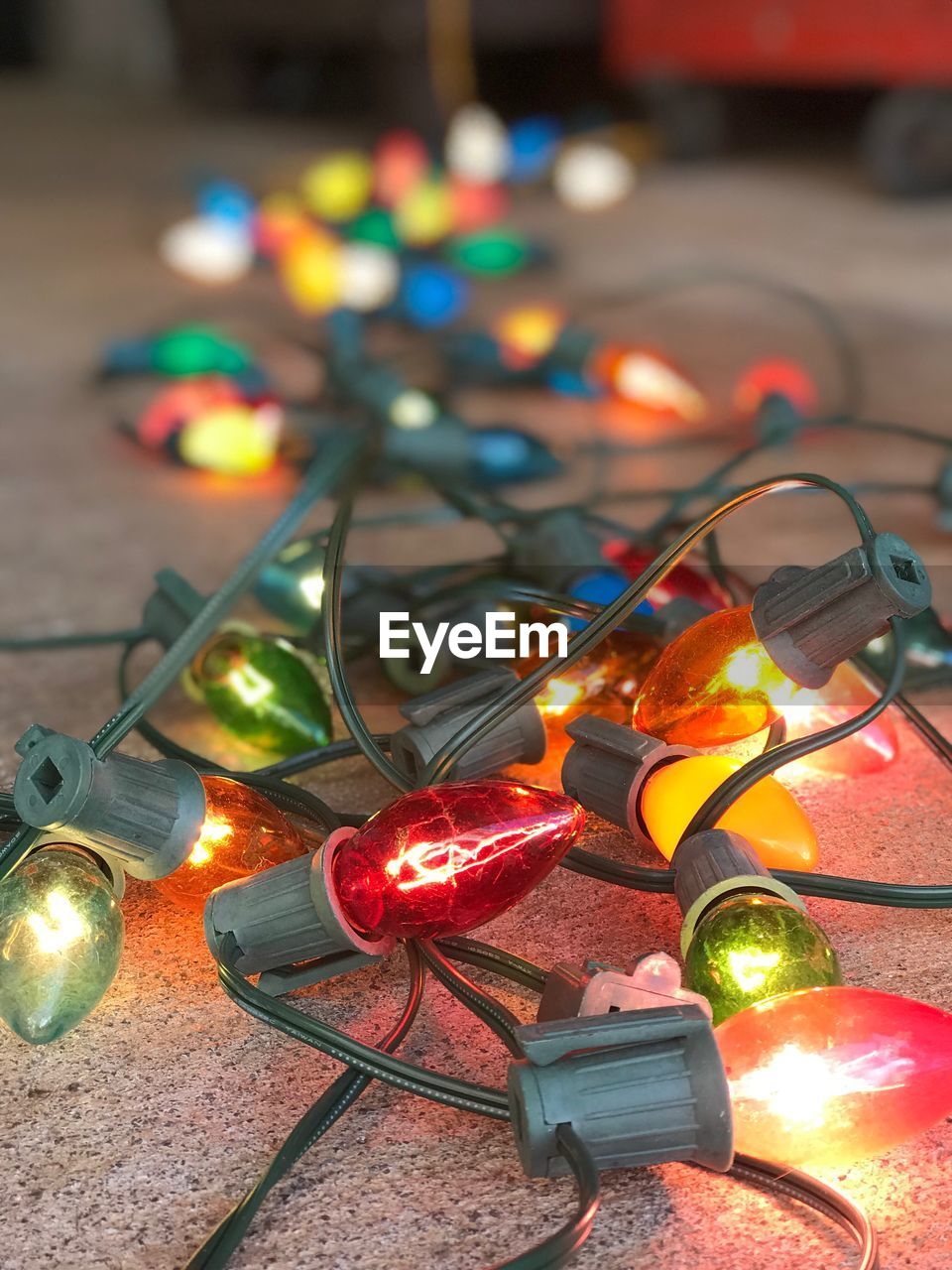 Close-up of illuminated christmas lights on carpet at home