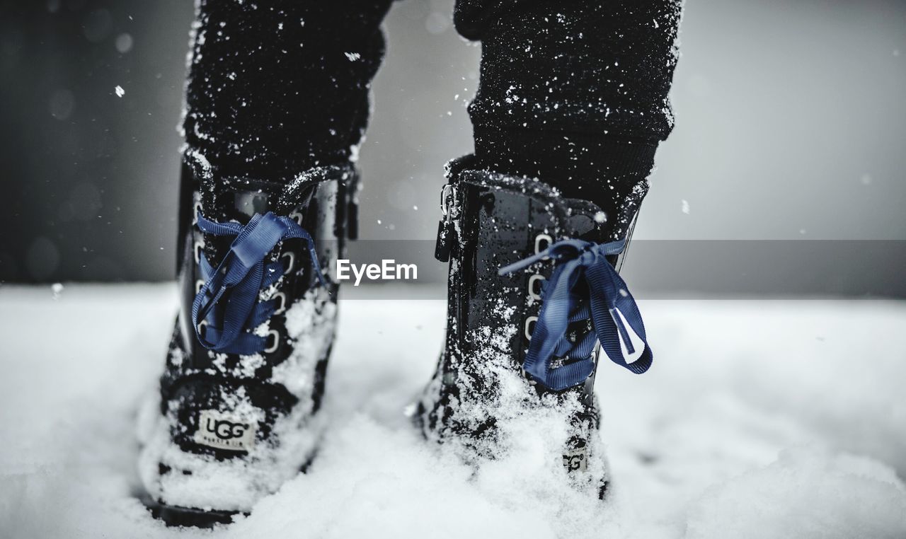 LOW SECTION OF PEOPLE ON SNOW COVERED WITH ICE