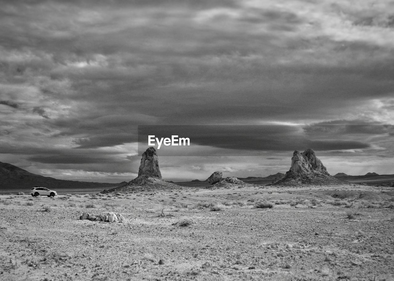 Rock formation at trona pinnacles against cloudy sky