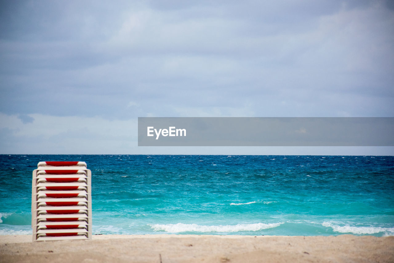 Scenic view of sea over beach against sky