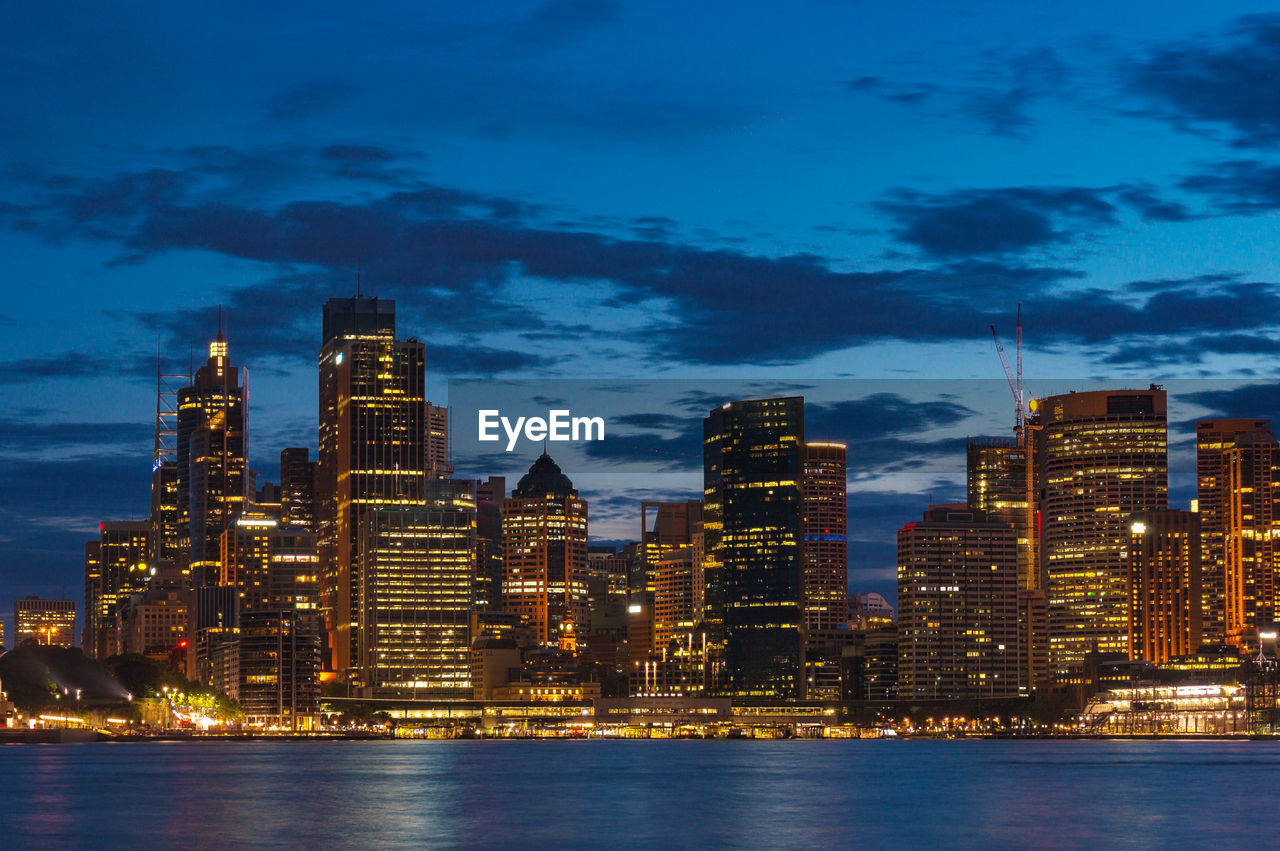 Sydney cityscape at dusk, blue hour with illuminated buildings of central business district, cbd