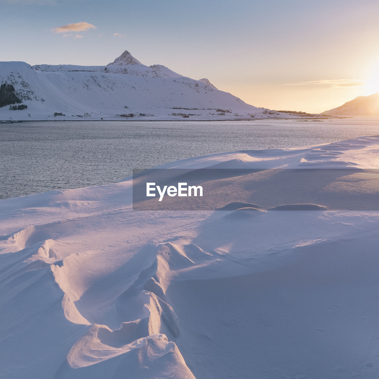 Scenic view of snowcapped mountains against sky during sunset