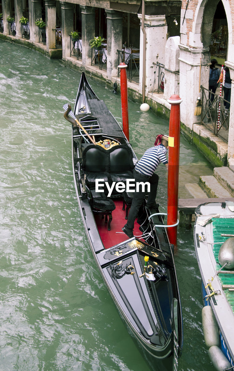 VIEW OF BOATS MOORED AT CANAL