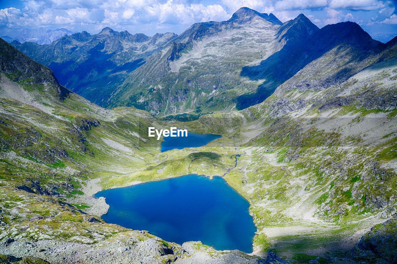 HIGH ANGLE VIEW OF LAKE AMIDST ROCKS