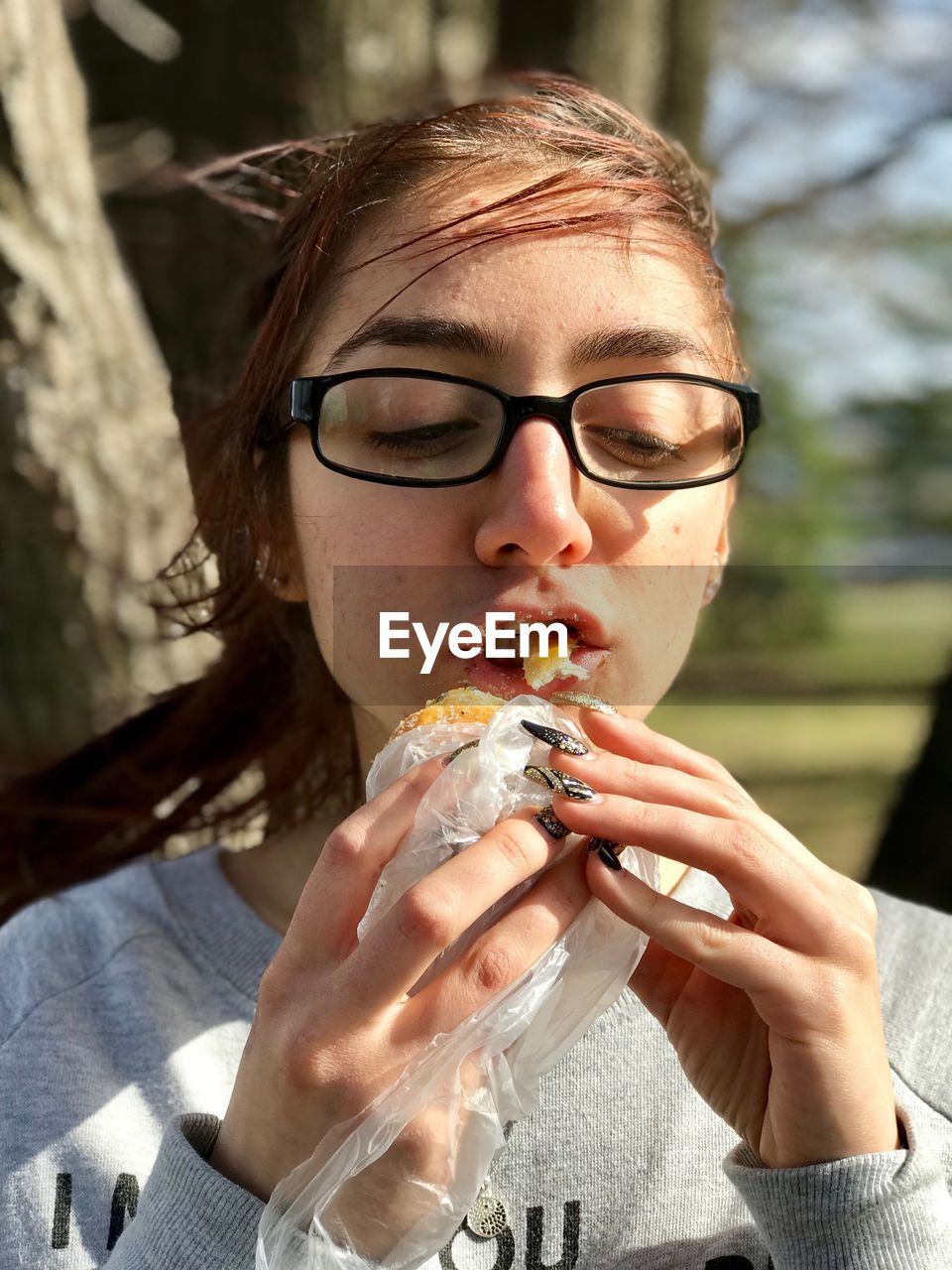 Close-up of young woman eating food