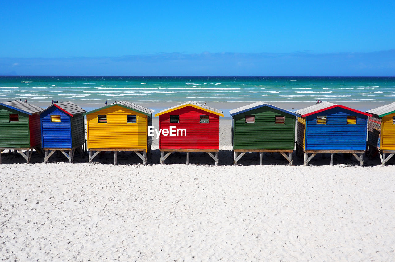 BEACH HUTS AGAINST SKY