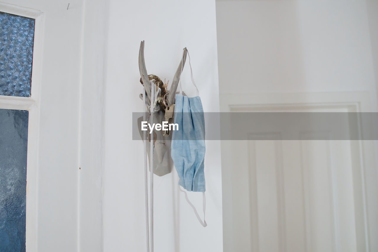 CLOTHES HANGING ON WHITE DOOR