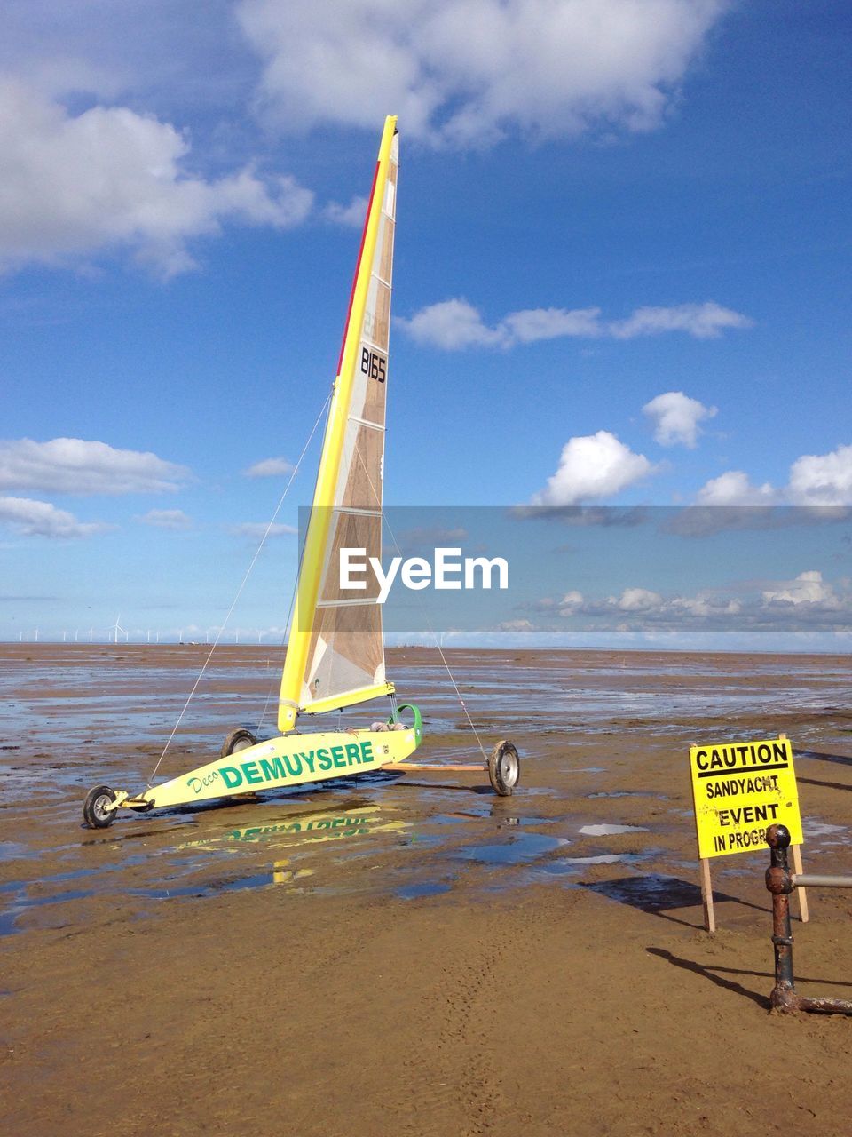 MAN ON BEACH AGAINST SKY