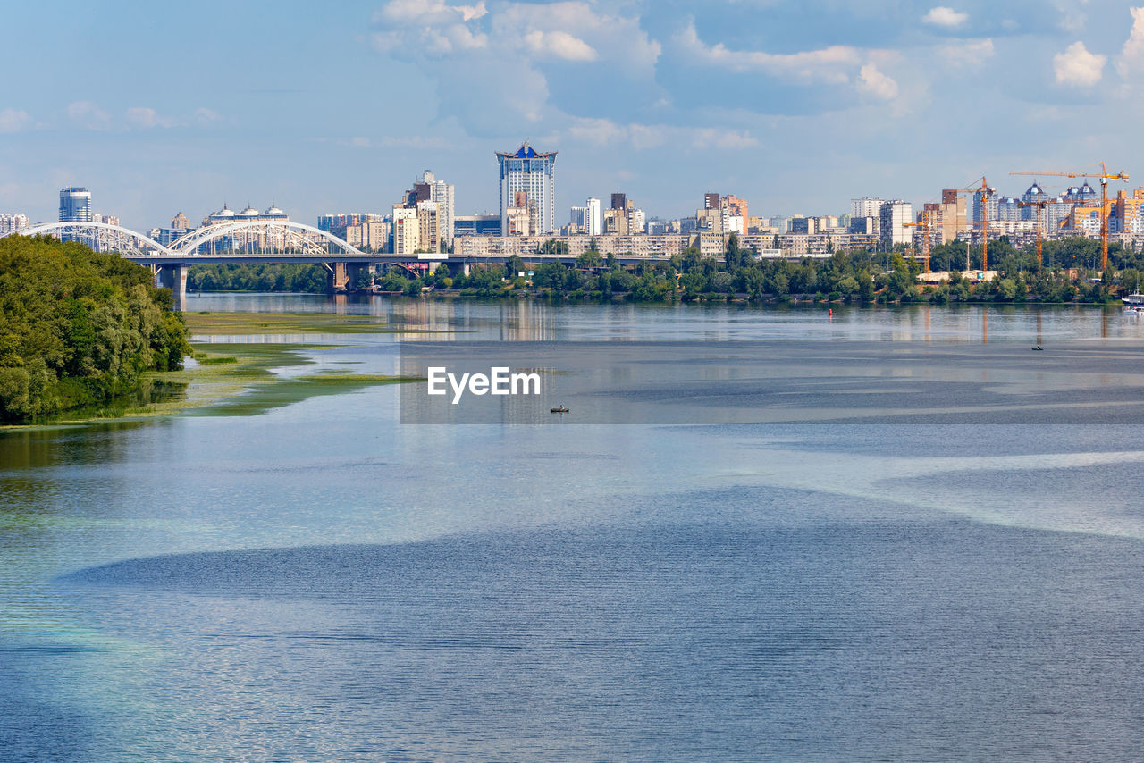 The beautiful left bank of the dnipro with a green island in the middle, on the horizon city of kyiv