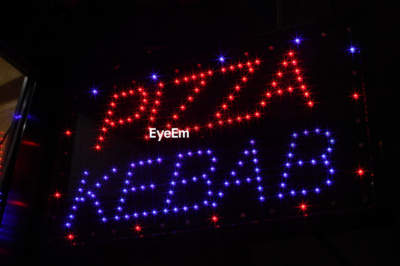 Text made with illuminated neon lights at night
