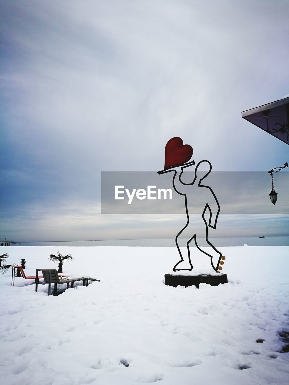 Scenic view of snow covered field against sky