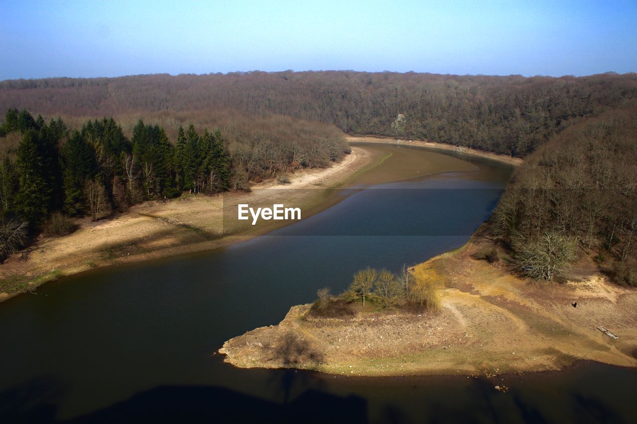 Scenic view of river by mountains against clear sky