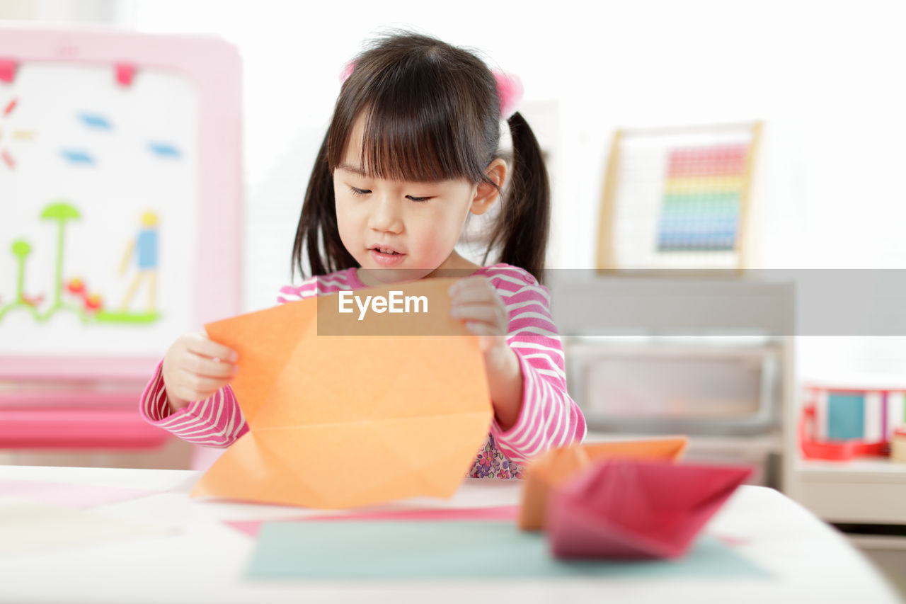 Young girl making craft for homeschooling