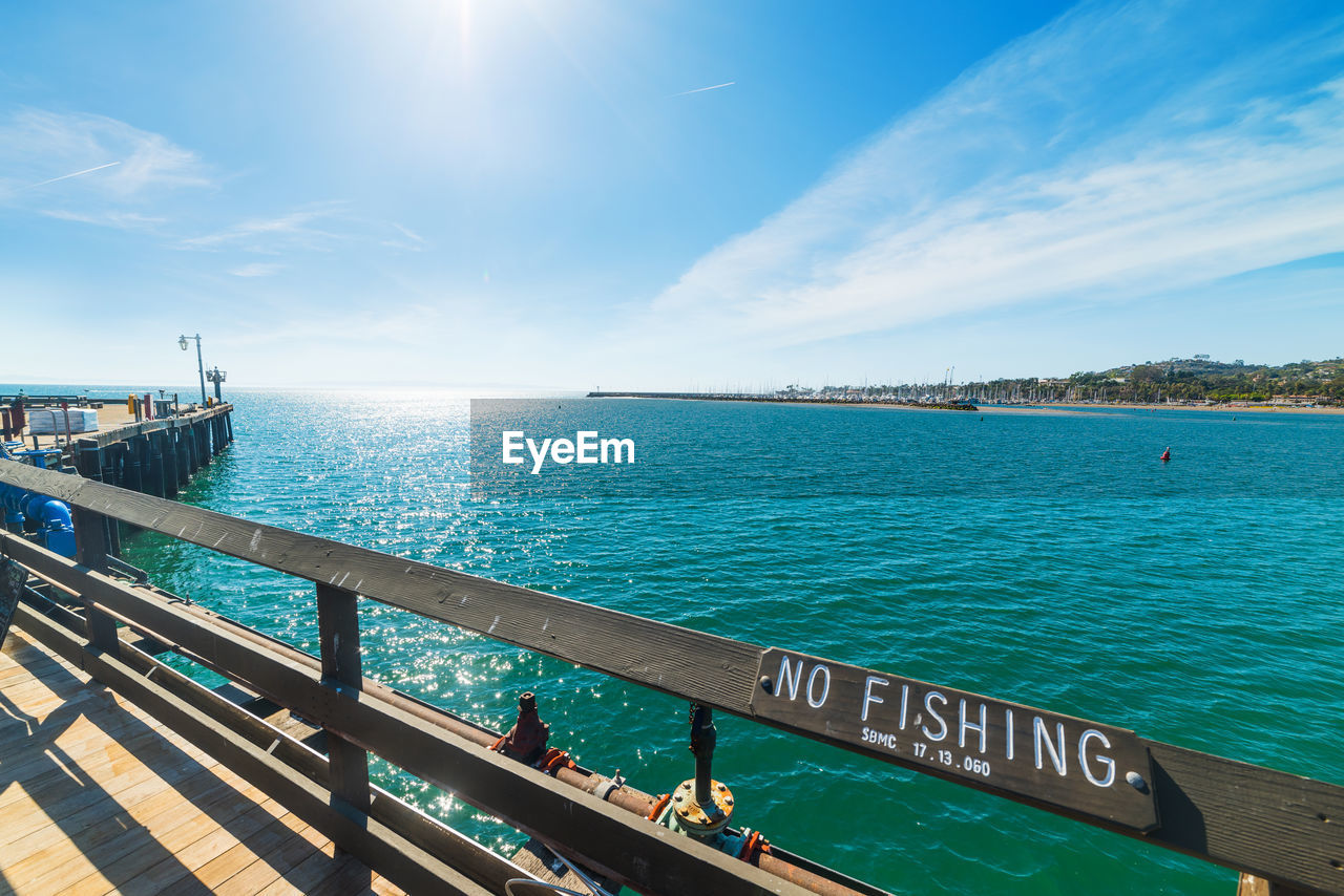 PIER OVER SEA AGAINST BLUE SKY