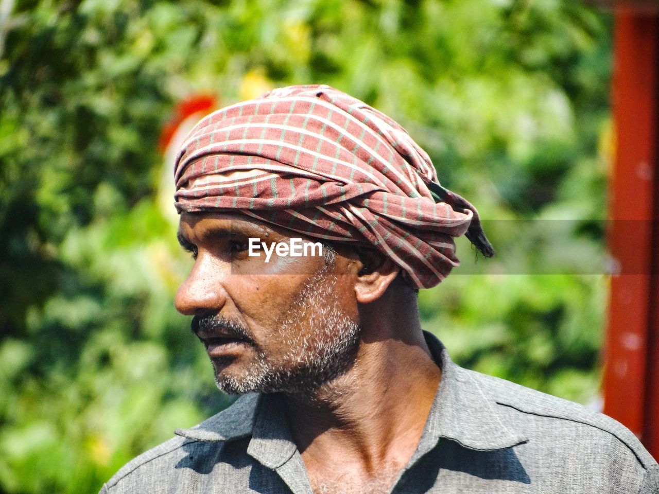 Close-up of man wearing turban looking away