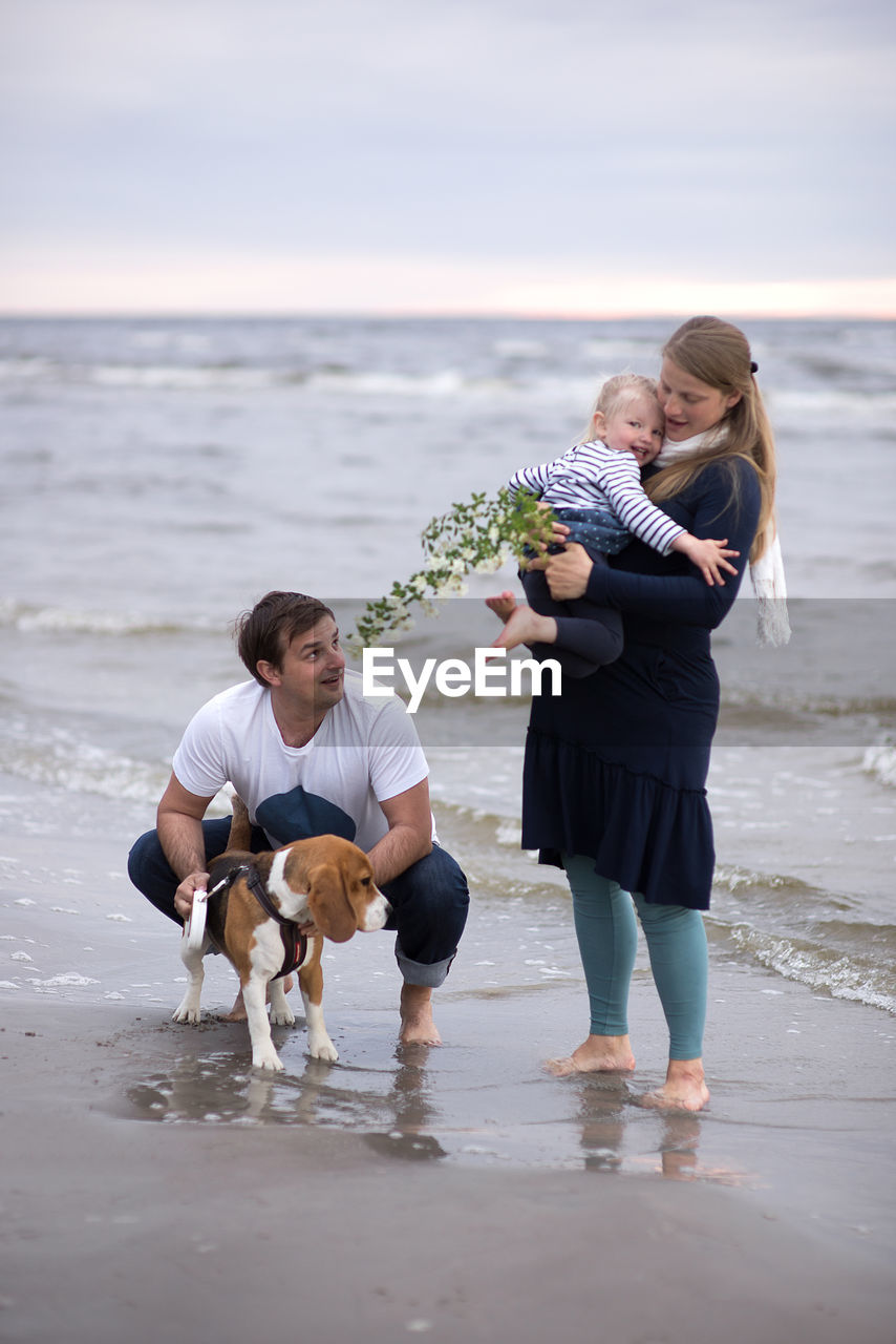 Full length of happy family at beach