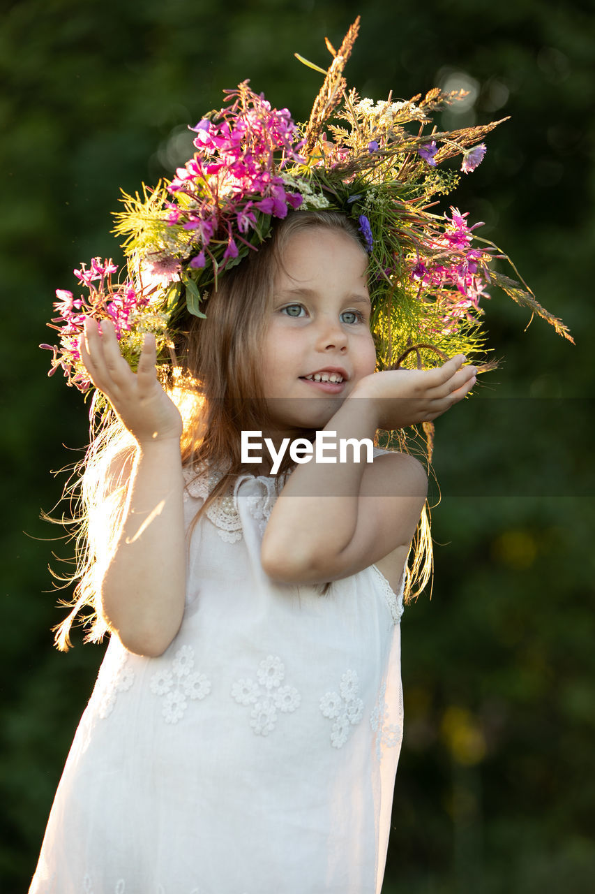 Beautiful little girl in a wreath