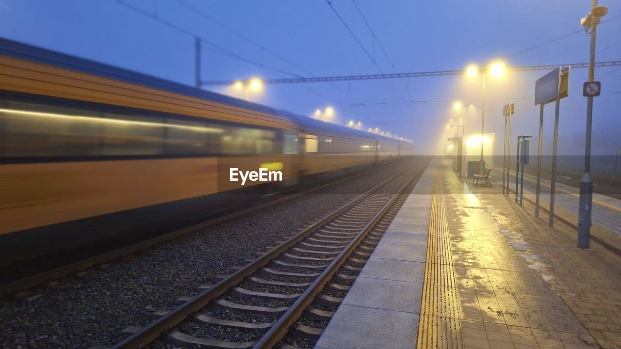 A passenger train entering the station in the fog. night train passing the station. the concept of