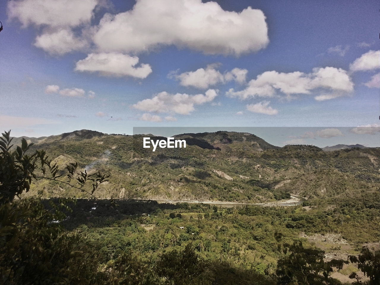 Scenic view of mountains against cloudy sky