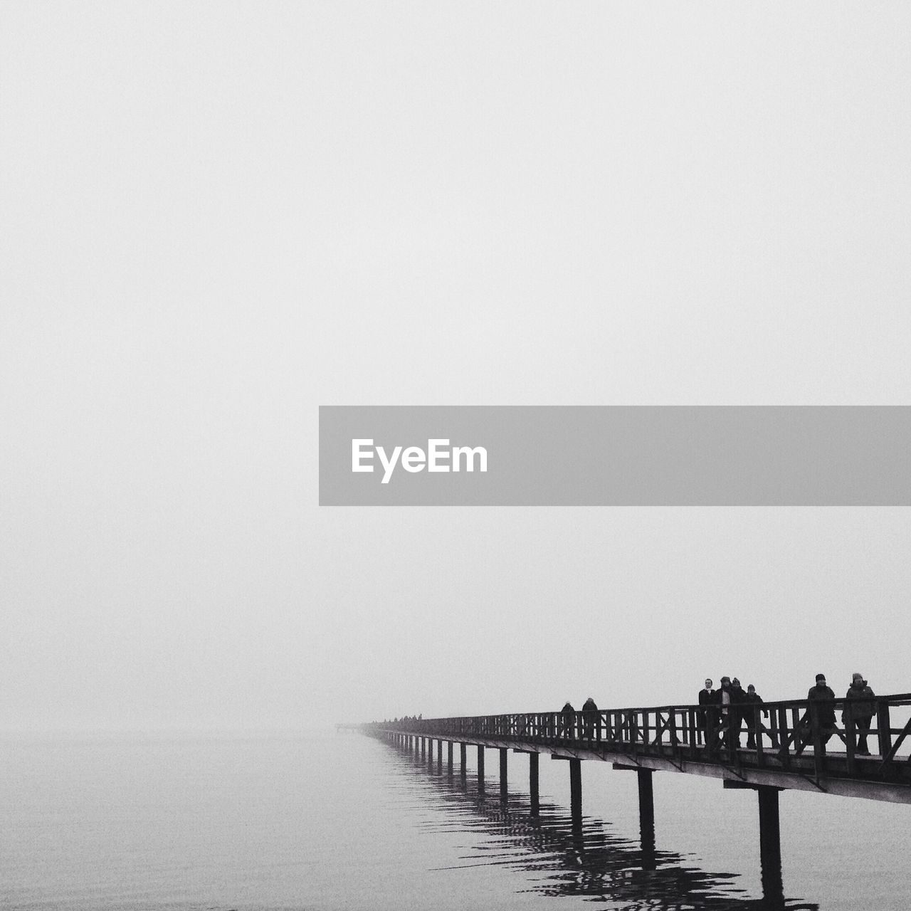Wooden pier over sea during foggy weather