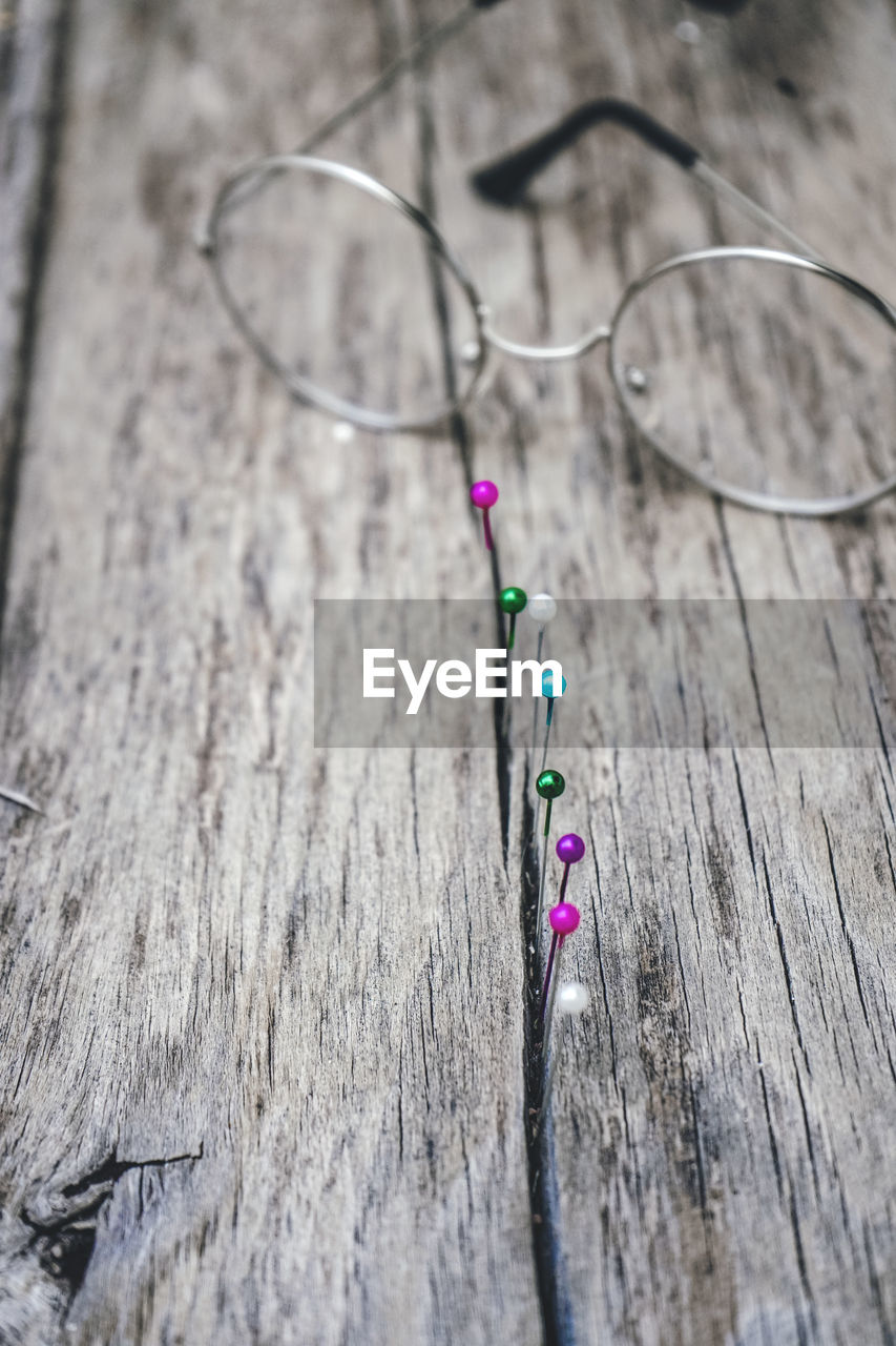 high angle view of eyeglasses on wooden wall