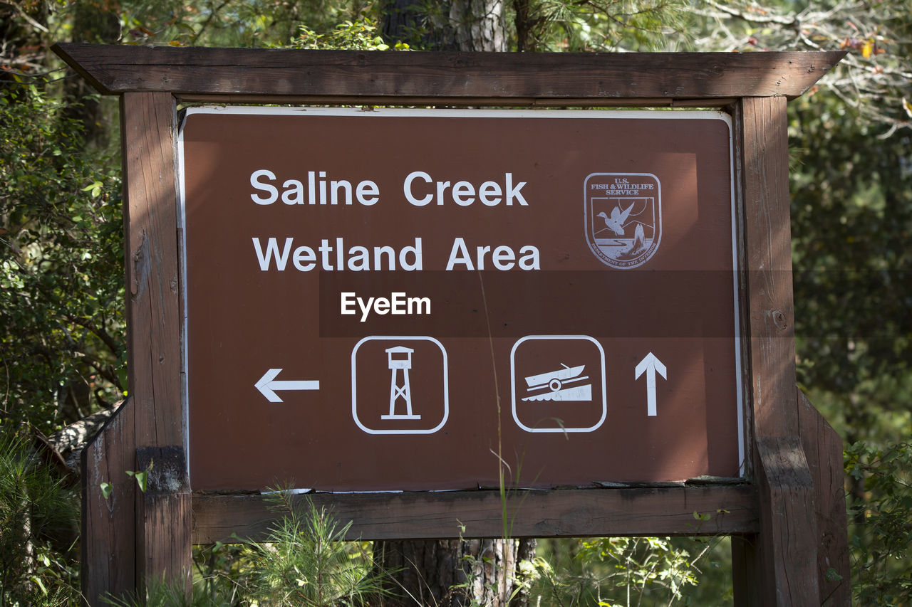 communication, sign, text, western script, plant, tree, no people, signage, public restroom, nature, state park, information sign, public building, day, bathroom, guidance, outdoors, trail, restroom sign, green, symbol