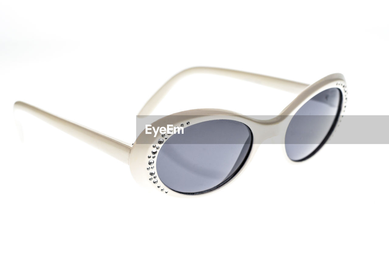 Close-up of sunglasses against white background