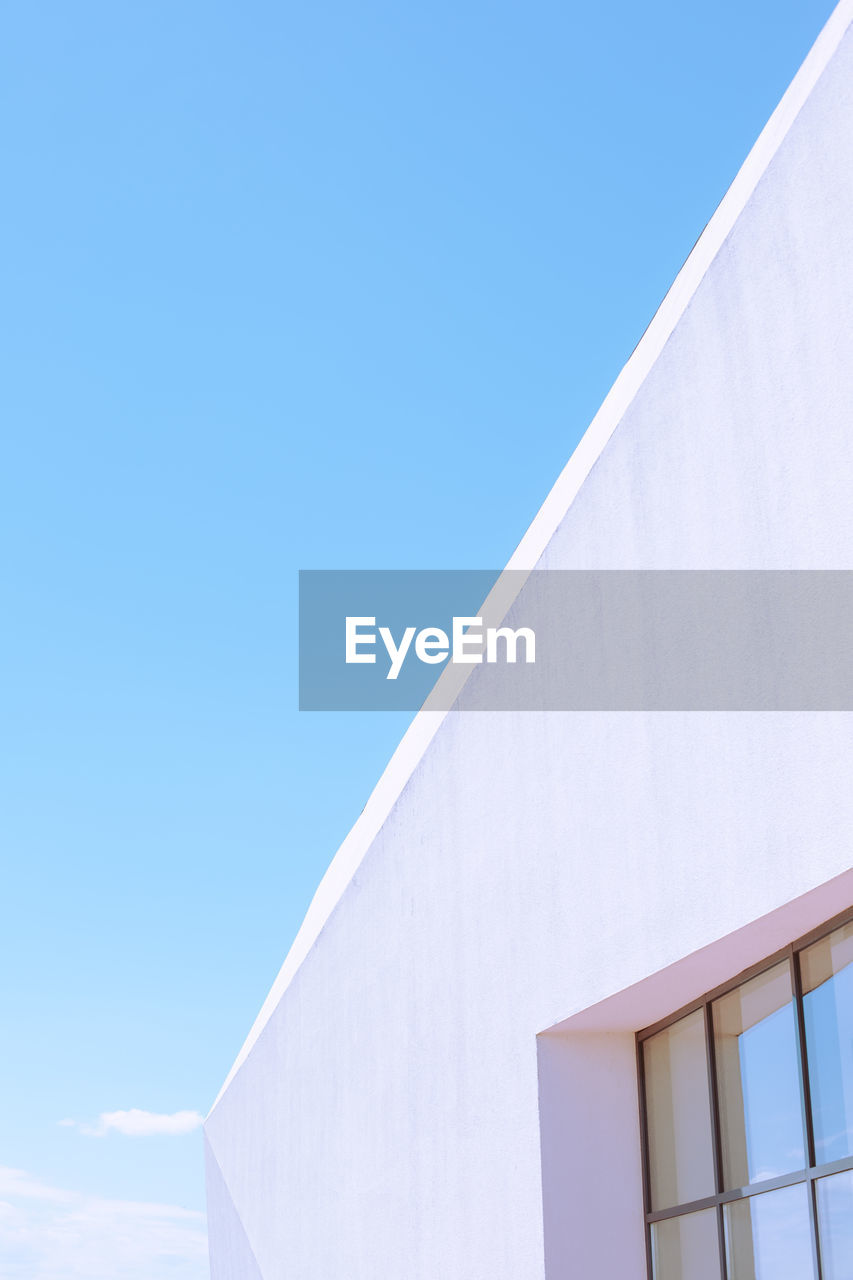 Low angle view of building against clear blue sky